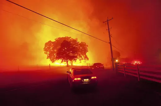 Residents flee as winds whip flames from the Morgan fire near Clayton, California on September 9, 2013.