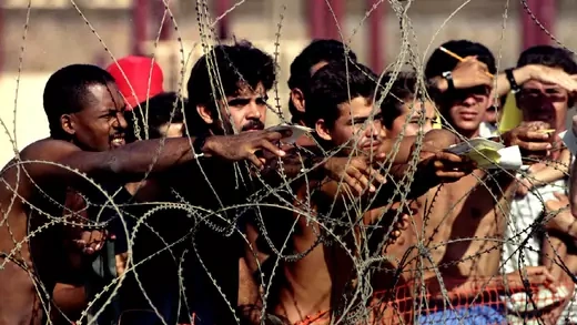 Cuban refugees behind barbed wire at Guantanamo Naval Base.