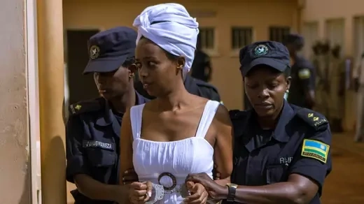 Diane Rwigara is held and escorted by two police officers in Rwanda.