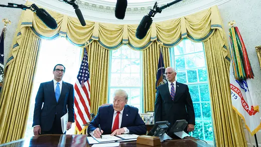 US President Donald Trump signs an executive order on Iran sanctions in the Oval Office of the White House