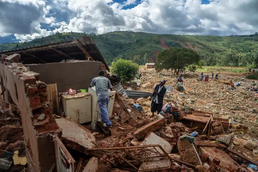 A man cleans up a destroyed house in Chimanimani.