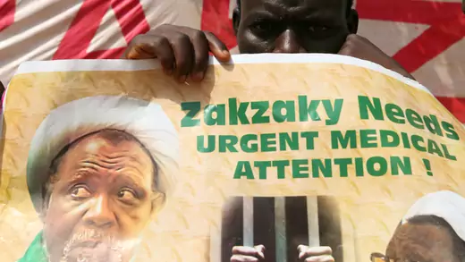 A protester holds a banner that reads, "Zakzaky needs urgent medical attention!"