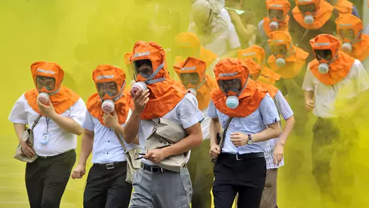 South Koreans wearing gas masks run out of a building during a civil defense drill in Seoul.