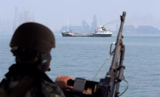 A U.S. Navy soldier onboard Mark VI Patrol Boat stands guard as an oil tanker makes its way towards Bahrain port, during an exercise of U.S./UK Mine Countermeasures (MCMEX) taking place in Arabian Sea, Bahrain September 11, 2018.