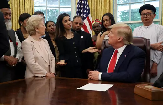 President Donald J. Trump listens to Nadia Murad as he hosts a group of victims of religious persecution in the Oval Office of the White House. Washington, DC, United States. July 17, 2019.