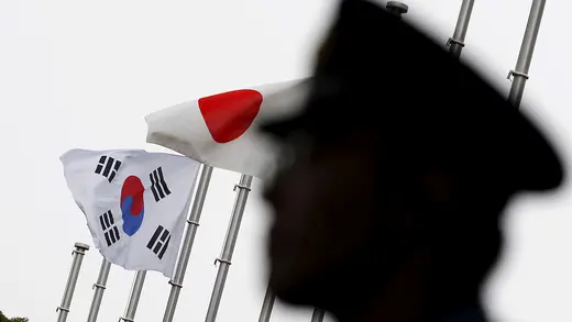 A South Korean and Japanese flag wave in the sky.