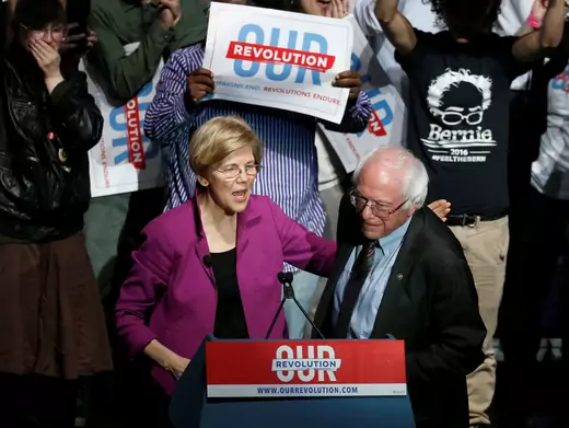 U.S. Senator Elizabeth Warren puts her arm around U.S. Senator Bernie Sanders after introducing him at a rally in Boston, Massachusetts, on March 31, 2017. 