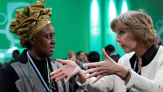 Kenyan delegate Alice Akinyi Kaudia talks with European Commissioner for Climate Action Connie Hedegaard during the conference. 