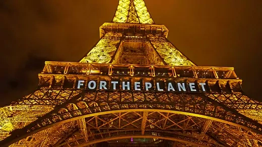 The Eiffel Tower is seen with the words 'For The Planet' displayed on it. 