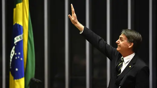 President-Elect Jair Bolsonaro waves inside the Congress building in the capital, Brasilia.