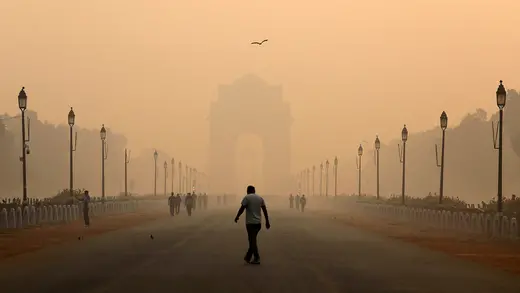 A man walks in front of the India Gate shrouded in smog in New Delhi, India, October 29, 2018.