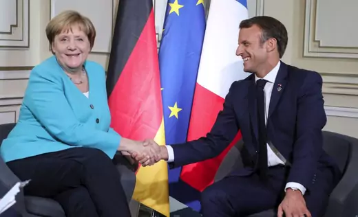 German Chancellor Angela Merkel shakes hands with French President Emmanuel Macron.