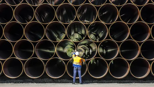 A worker inspects pipes for the Nord Stream 2 at a site on Germany's Baltic Sea coast.