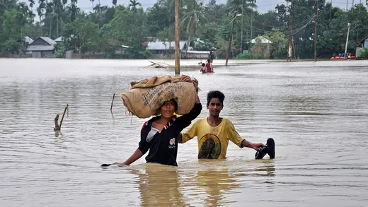 Boys wade through a flooded village on the outskirts of Agartala, India, October 22, 2017.
