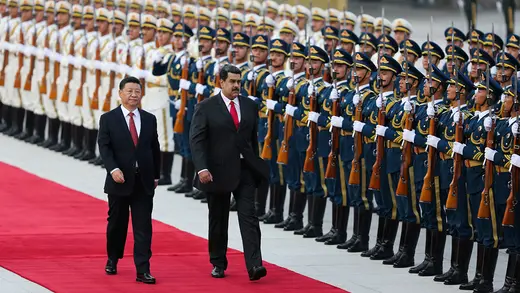 Chinese President Xi Jinping walks next to Venezuela's President Nicolas Maduro during a welcoming ceremony in Beijing in September 2018.