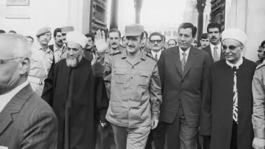 Syrian President Hafez al-Assad waves as he walks out of the Omayyades mosque in Damascus in October 1973.  