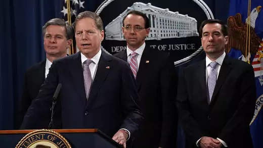 U.S. Attorney for the Southern District of New York Geoffrey Berman (2nd L) speaks as (L-R) FBI Director Christopher Wray, U.S. Deputy Attorney General Rod Rosenstein and Assistant Attorney General for National Security John Demers listen during a news conference to announce a China related national security law enforcement action December 20, 2018 at The Justice Department in Washington, DC. The Justice Department has filed charges against two Chinese national individuals, Zhu Hua and Zhang Shilong who bel