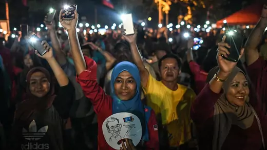 Opposition supporters turn on flashlights on their phones after former Malaysian Prime Minister Mahathir Mohamad was elected as a parliamentary constituency candidate during a rally ahead of the 14th general election in Malaysia on April 15, 2018.