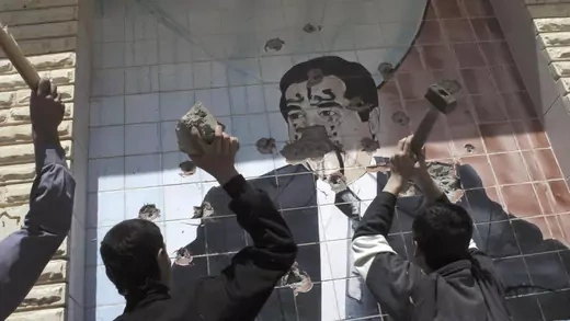 A portrait of Saddam Hussein is shown being destroyed in Kirkuk on April 10, 2003. Kurdish troops captured Kirkuk with the aid of American troops during the U.S. invasion of Iraq.  