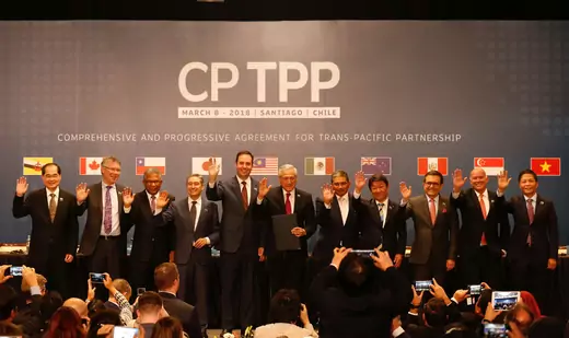 Representatives of members of Trans-Pacific Partnership (TPP) trade deal wave as they pose for an official picture after the signing agreement ceremony in Santiago, Chile March 8, 2018.