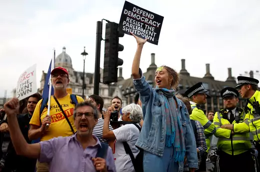 Anti-Brexit protestors hold placards outside the Houses of Parliament in London.