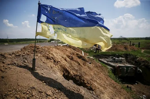 A tattered Ukrainian national flag flutters in the wind near the town of Maryinka, eastern Ukraine.