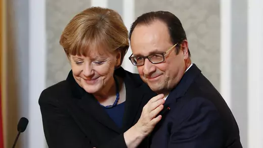 Chancellor Angela Merkel embraces President Francois Hollande