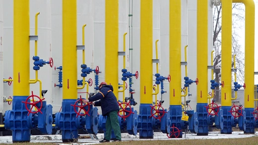 A Ukrainian operator turns a valve at a gas pipeline