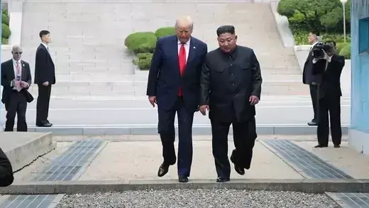 Trump and Kim step across the border between North and South Korea.