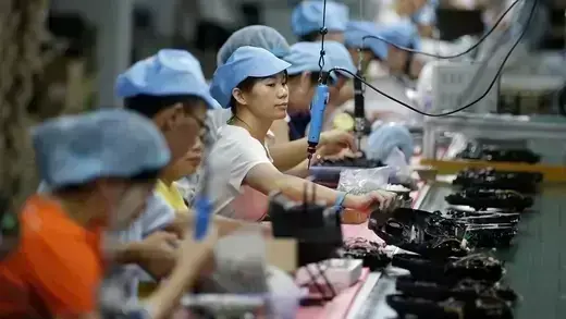 Workers on the production line of a factory in Shenzhen, China, in August 2019.