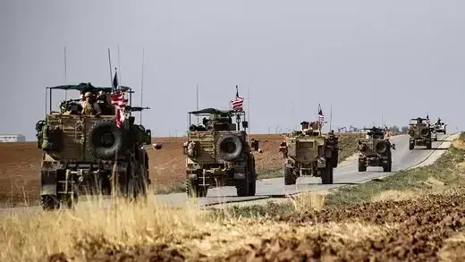 A convoy of U.S. armored vehicles patrols a stretch of the Syria-Turkey border in October 2019.