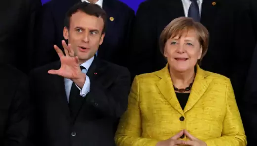 French President Emmanuel Macron and German Chancellor Angela Merkel take part in the launching of the Permanent Structured Cooperation (PESCO).