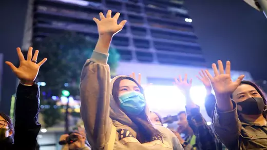 Protesters raise their hands outside Polytechnic University in Hong Kong.
