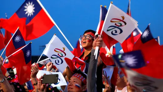 People wave Taiwan and KMT flags. 