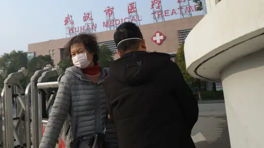 A woman wearing a face mask leaves a medical center in Wuhan, China.