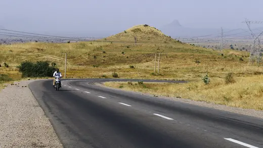 A man rides his motorbike along Gombe Numan highway in Gombe state, on November 29, 2013.