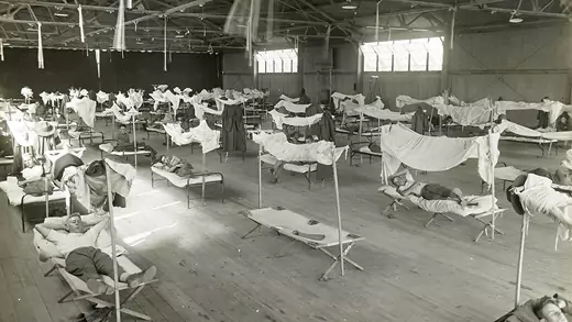 Influenza patients lie on cots at a makeshift treatment center in Lonoke, Arkansas, in November 1918.