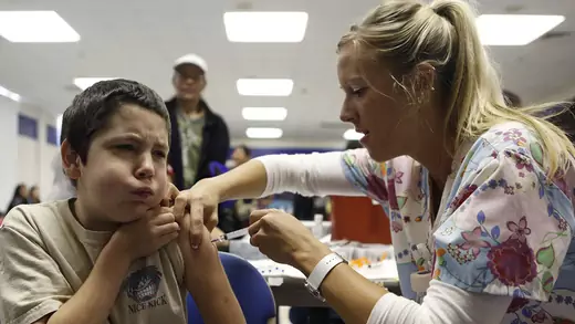 A nurse administers the H1N1 vaccine to ten-year-old Anthony Adams in Haltom City, Texas, in October 2009.