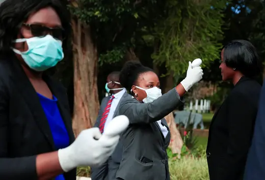 Health workers screen visitors to prevent the spread of COVID-19 at State House in Harare, Zimbabwe, March 19, 2020