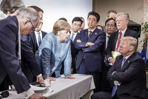 German Chancellor Angela Merkel deliberates with US president Donald Trump on the sidelines of the official agenda on the second day of the G7 summit on June 9, 2018 in Charlevoix, Canada.