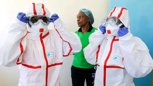 Kenyan nurses wear white protective suits, face masks, goggles, hoods, and blue medical gloves during a demonstration of preparations for any potential coronavirus cases at the Mbagathi Hospital, isolation center for the disease, in Nairobi, Kenya, on March 6, 2020.