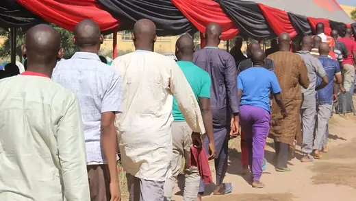 Freed inmates walk in a line after they were released and handed over to state officials for rehabilitation and integration after they were detained for up to four years over suspicion of links with Boko Haram jihadists during an official ceremony at the Giwa military barracks, in Maiduguri, on November 27, 2019.