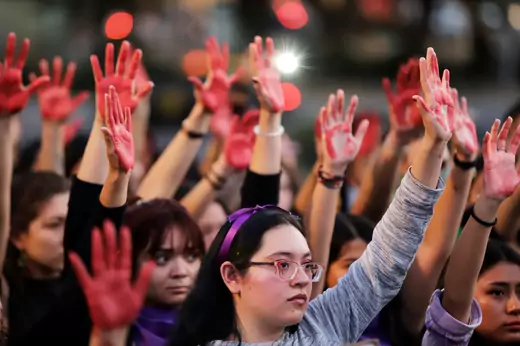 Women raise their hands as they protest against gender violence and femicide in Puebla, Mexico, February 22, 2020.