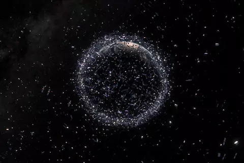Fragments of space junk surround a planet against blackness and a field of stars. 