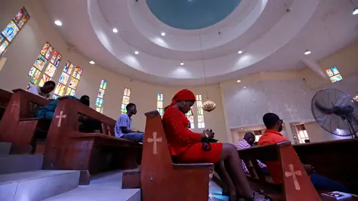 Christian worshippers sit spaced out in elevated pews during a mass at the mostly empty St Gabriel Catholic church, as government struggles to control the spread of the coronavirus disease (COVID-19) in Abuja, Nigeria March 22, 2020. Lockdown orders were issued for March 30.