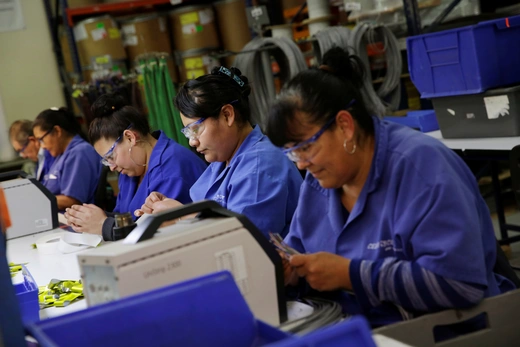 Operators work at a wire harness and cable manufacturing plant as the fast-spreading coronavirus outbreak has rippled through the global economy and upended supply chains, in Ciudad Juarez, Mexico.