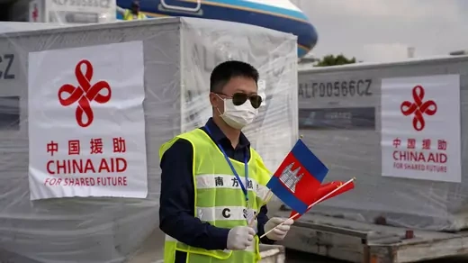 An airport worker is seen as a Chinese plane arrives with medical workers and supplies donated from China to Cambodia.