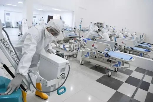A medical officer checks devices at an emergency hospital.