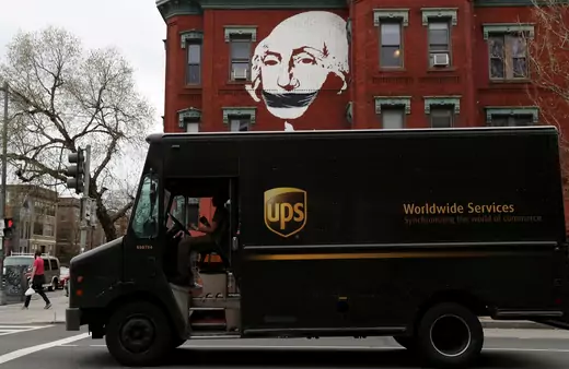  A local mural takes on new meaning while a United Parcel Service (UPS) delivery truck pauses at a traffic light, as the spread of coronavirus disease (COVID-19) continues in Washington, U.S., March 27, 2020.