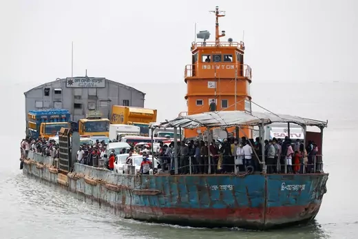A ferry barge packed with people and vehicles